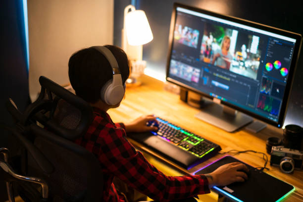 Professional Videographer Works on Desktop Computer